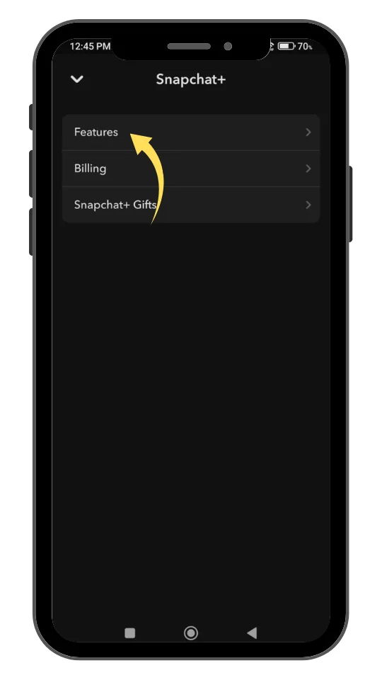 A smartphone screen displaying the Snapchat+ menu. An arrow points to the "Features" option at the top of the list, indicating the next step. Other options listed below are "Billing" and "Snapchat+ Gifts." The screen has a dark background with a simple layout.