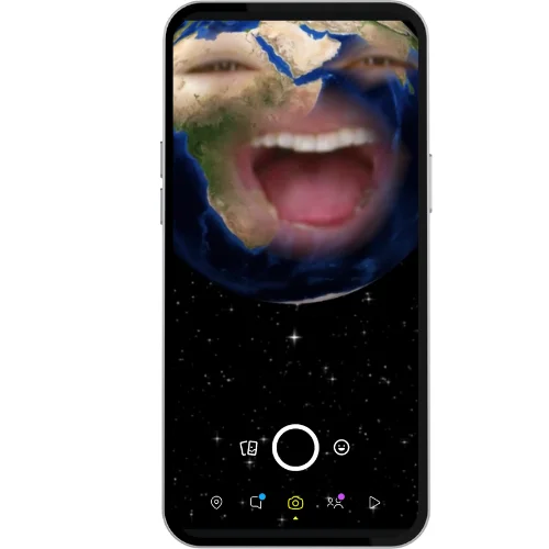 A smartphone screen showing a Snapchat lens where the Earth is animated with a human face, featuring wide eyes and a mouth open in laughter, floating in outer space.